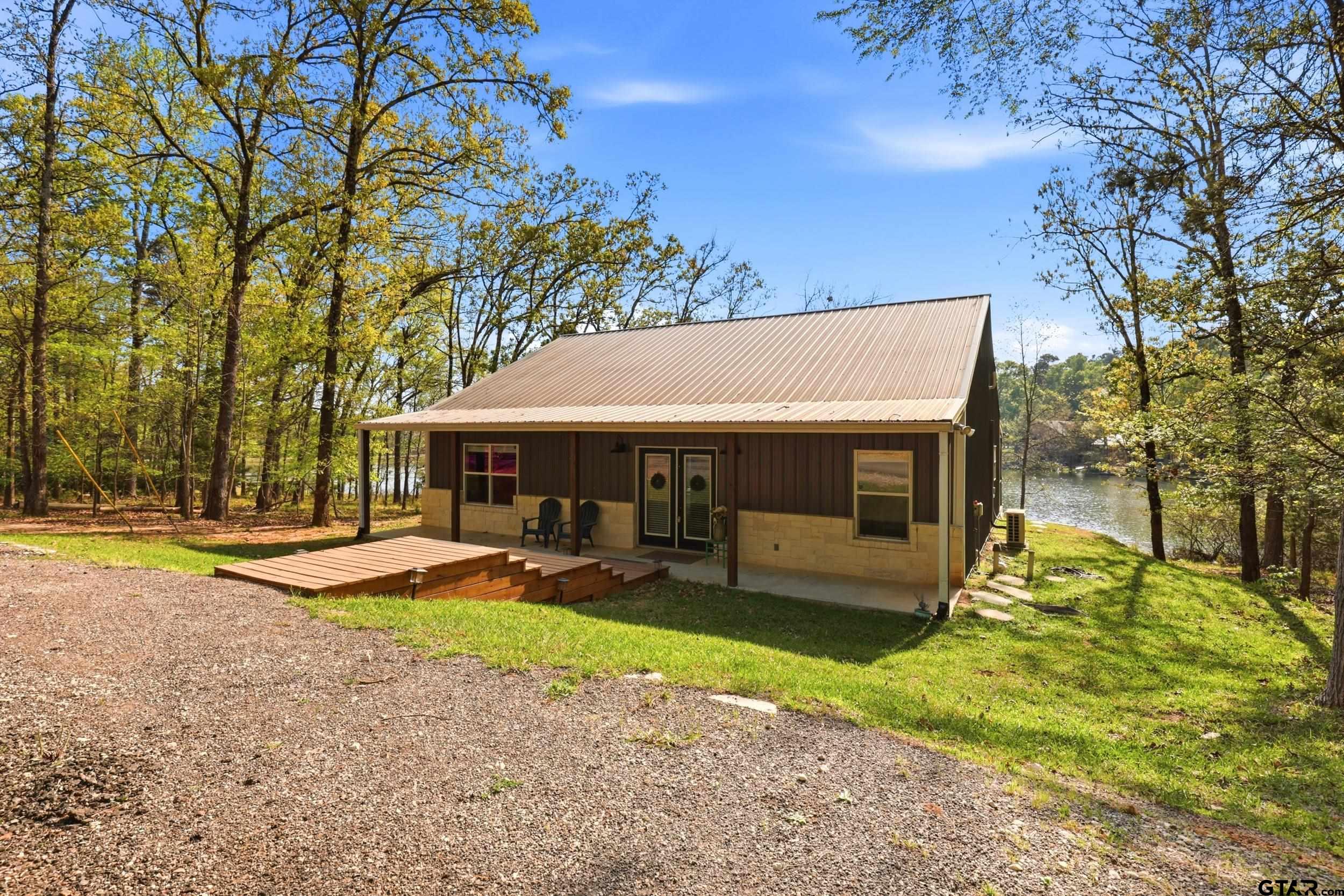 132 King George Road Scroggins, TX 75480 - Photo 22 of 35 a view of a house with backyard and sitting area