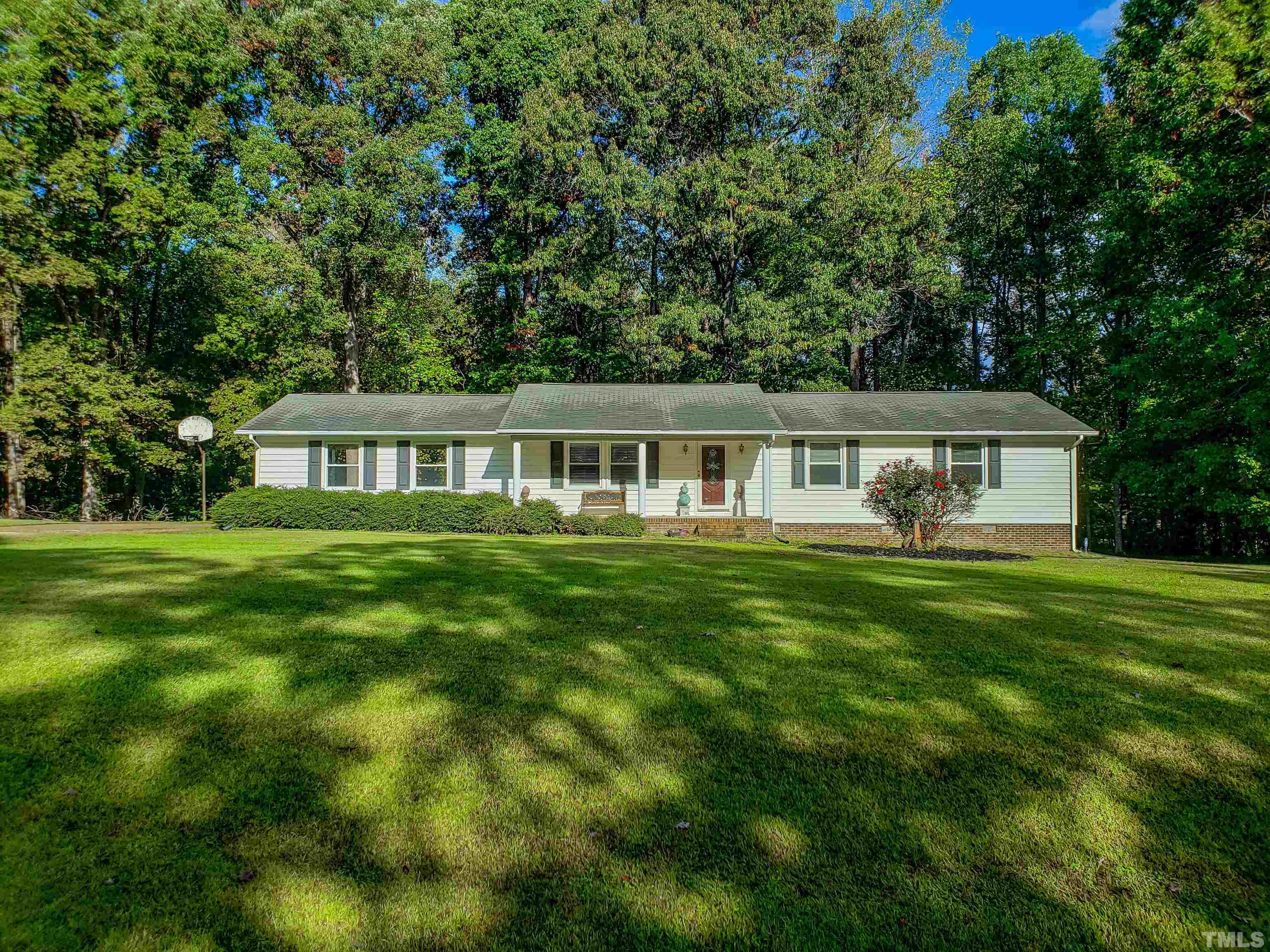 a front view of house with a garden