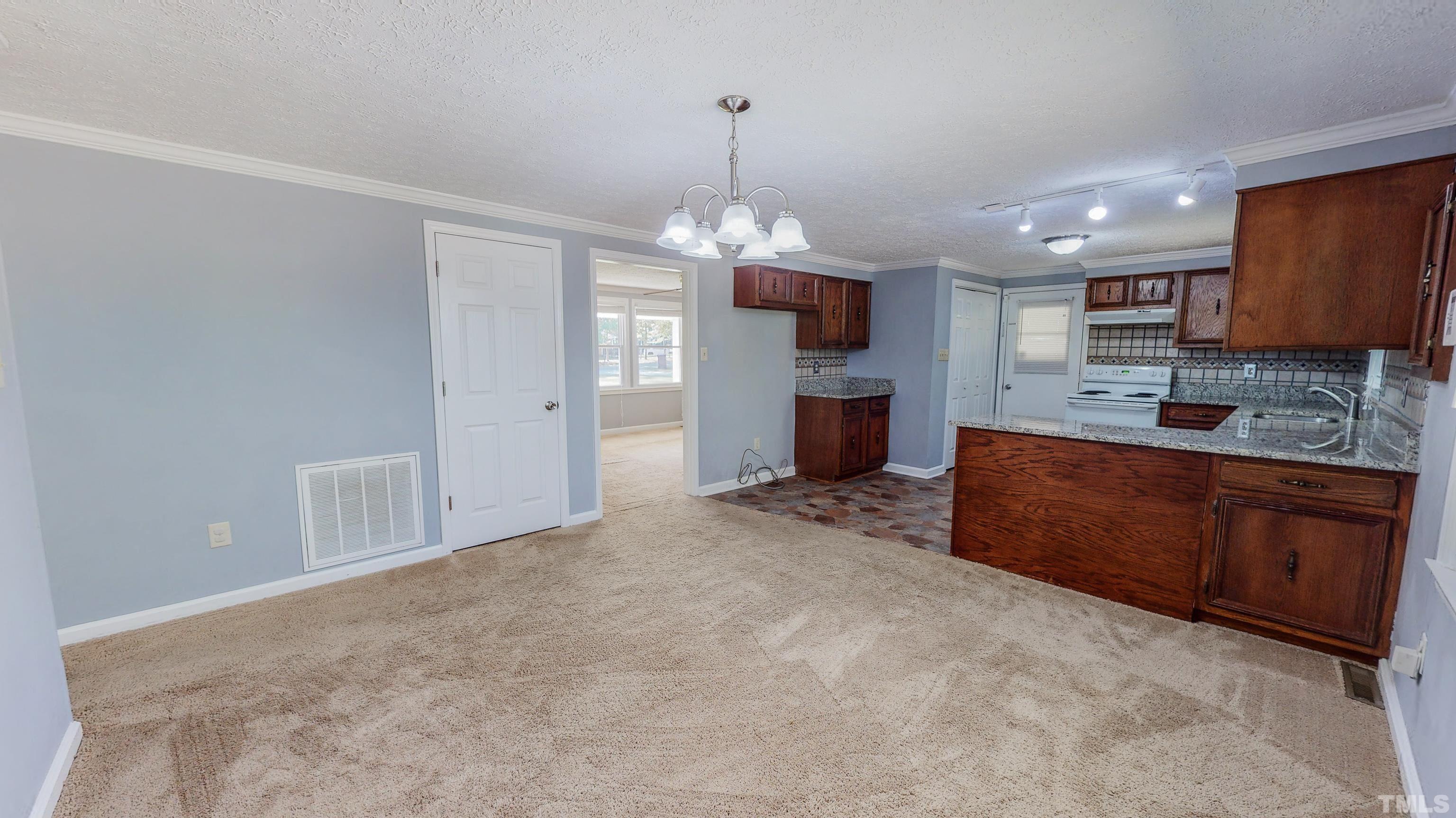 180 Dancy Day Road Roxboro, NC 27574 - Photo 2 of 30 a kitchen with stainless steel appliances granite countertop a sink refrigerator and cabinets
