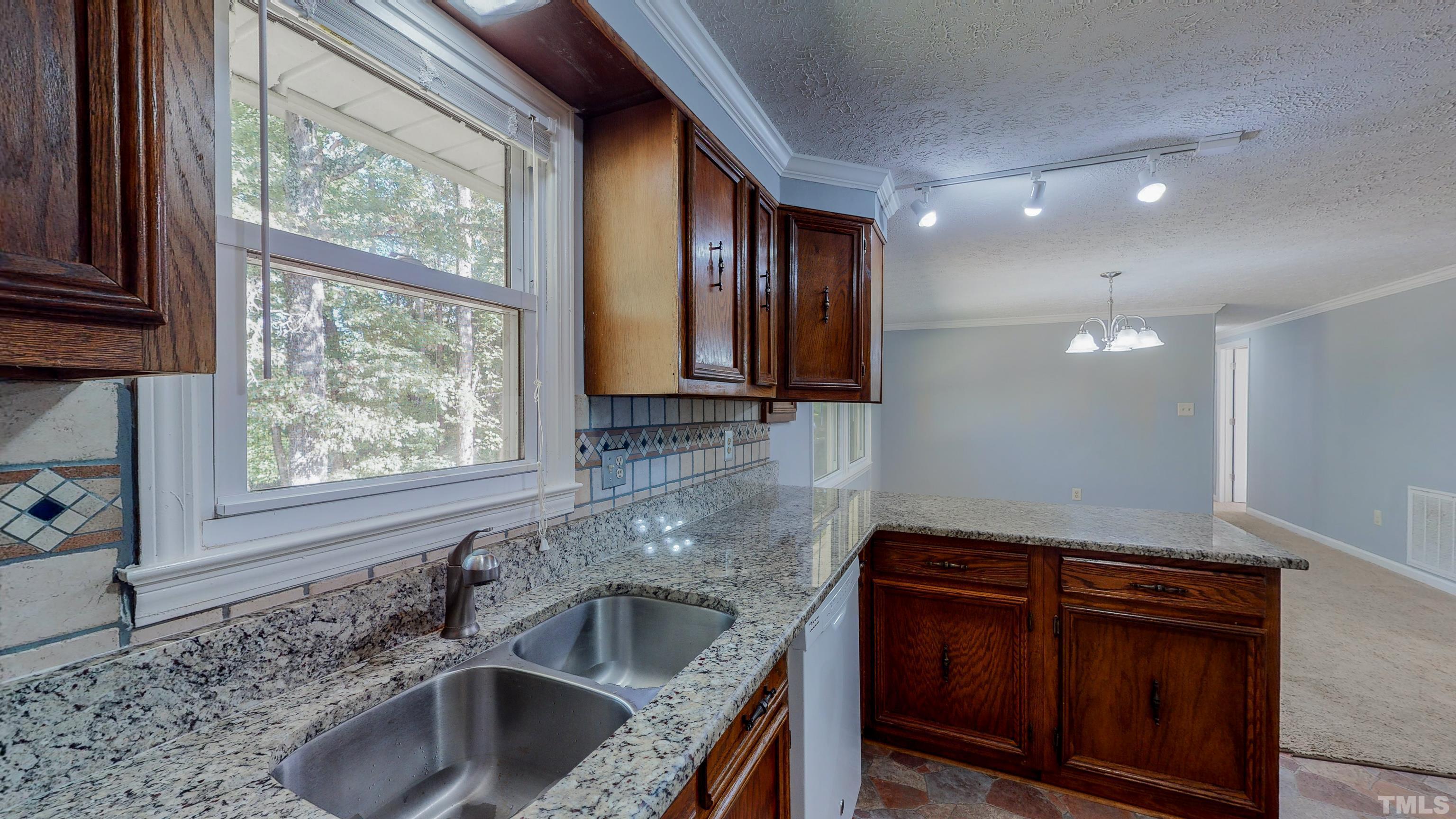 180 Dancy Day Road Roxboro, NC 27574 - Photo 11 of 30 a kitchen that has a sink and a stove in it