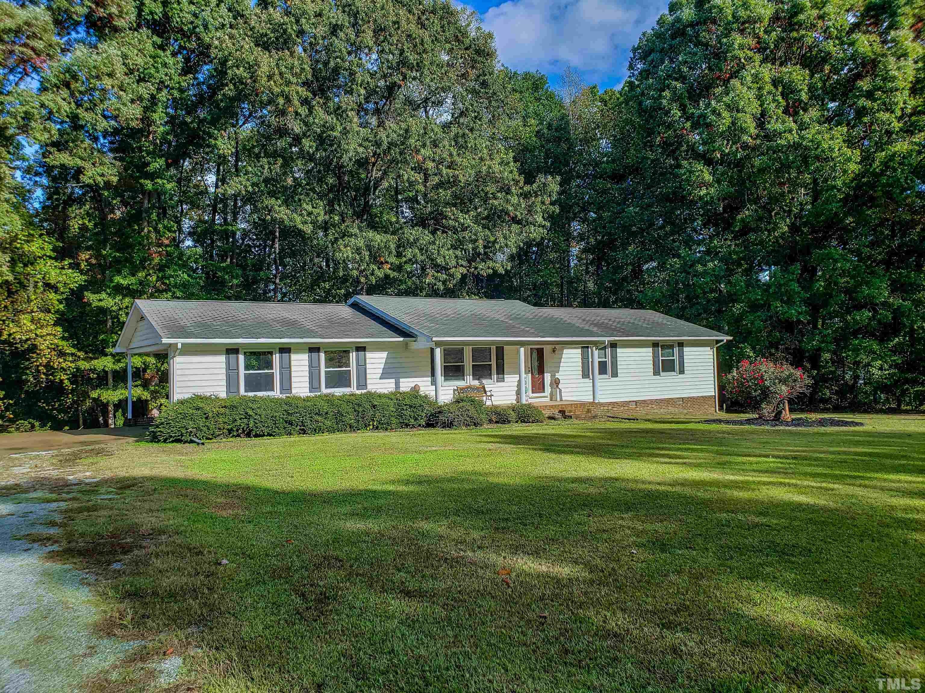 180 Dancy Day Road Roxboro, NC 27574 - Photo 18 of 30 a front view of a house with a garden