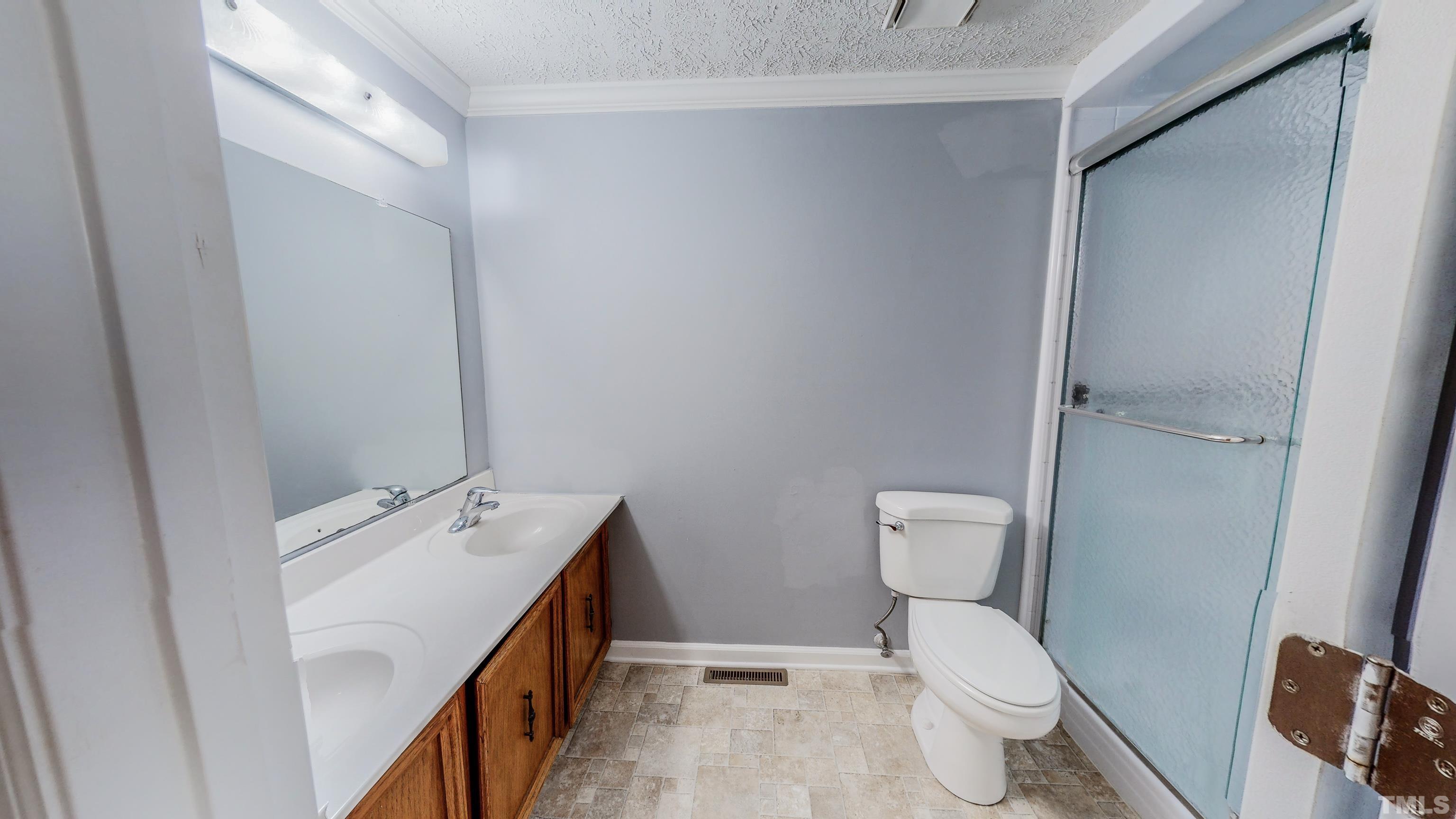 180 Dancy Day Road Roxboro, NC 27574 - Photo 23 of 30 a bathroom with a toilet sink and mirror