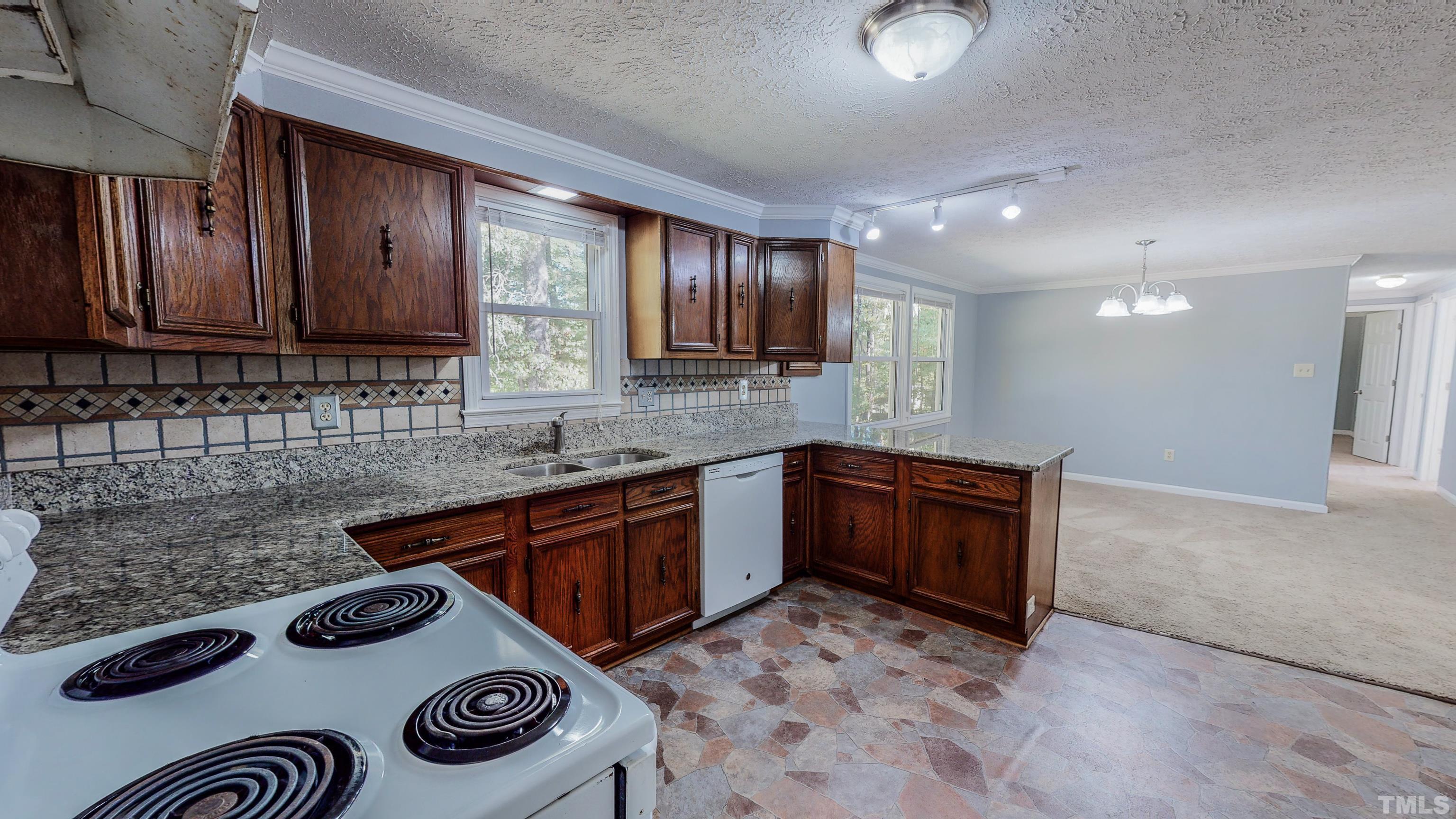 180 Dancy Day Road Roxboro, NC 27574 - Photo 4 of 30 a kitchen with a sink a stove and cabinets