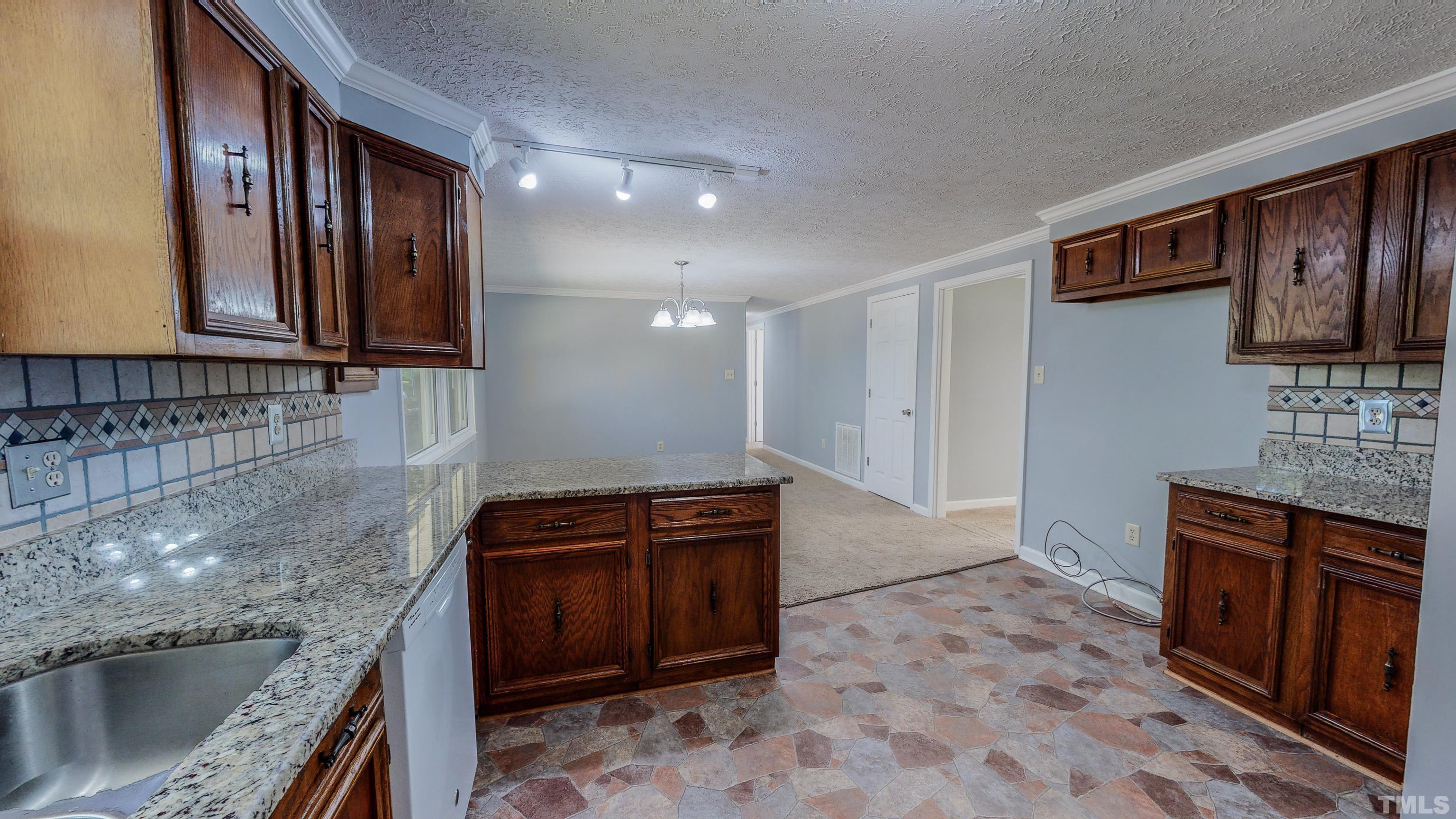 180 Dancy Day Road Roxboro, NC 27574 - Photo 10 of 30 a kitchen with stainless steel appliances granite countertop a stove a sink and a microwave