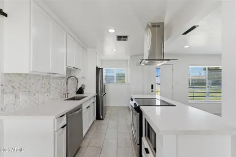 a kitchen with refrigerator and furniture