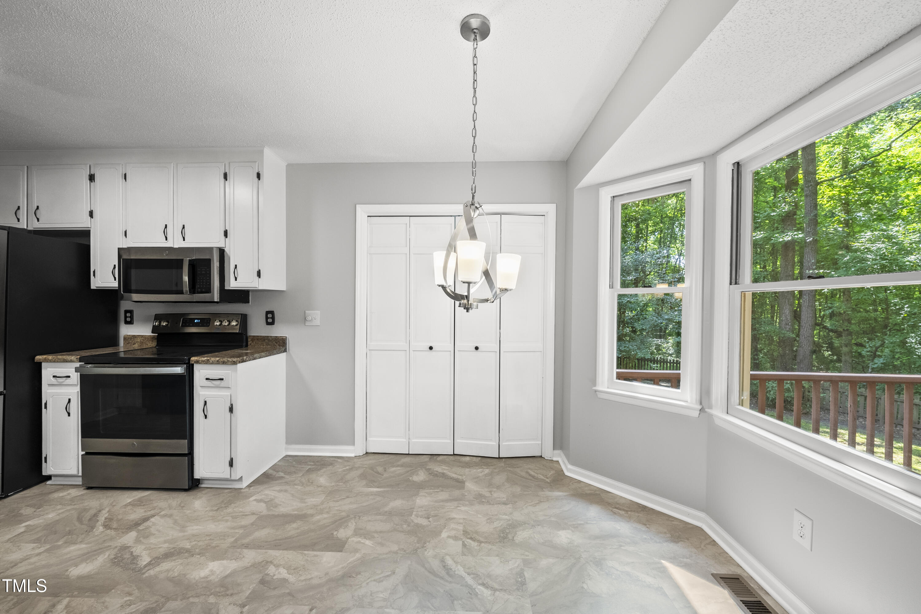 6009 Shadow Moss Circle Raleigh, NC 27603 - Photo 15 of 37 a kitchen with stainless steel appliances granite countertop a stove a sink and a granite counter tops