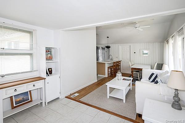 14 Lincoln Road Hampton Bays, NY 11946 - Photo 11 of 34 a living room with furniture and view of kitchen