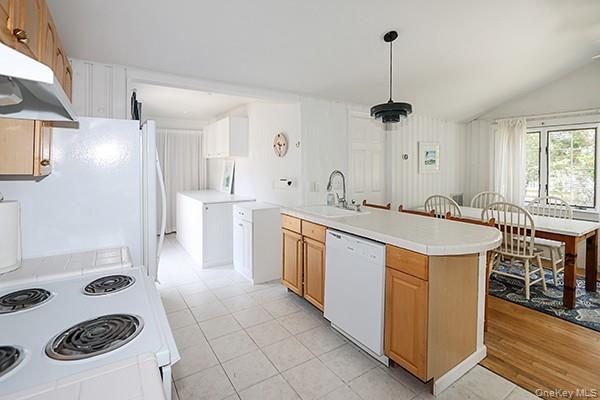 14 Lincoln Road Hampton Bays, NY 11946 - Photo 16 of 34 a kitchen with a sink a stove a refrigerator and furniture