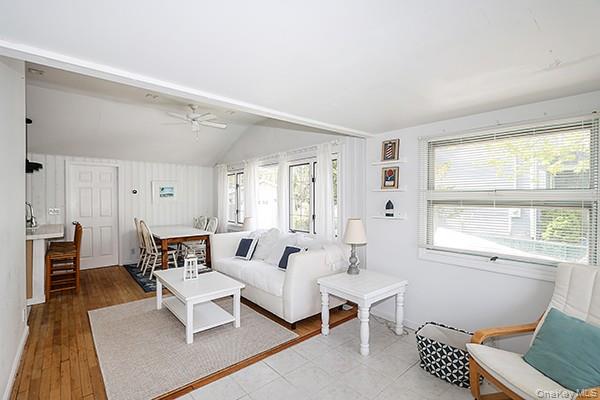 14 Lincoln Road Hampton Bays, NY 11946 - Photo 18 of 34 a living room with furniture a rug and a window