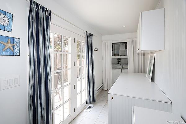 14 Lincoln Road Hampton Bays, NY 11946 - Photo 20 of 34 a view of a kitchen with a refrigerator and a window