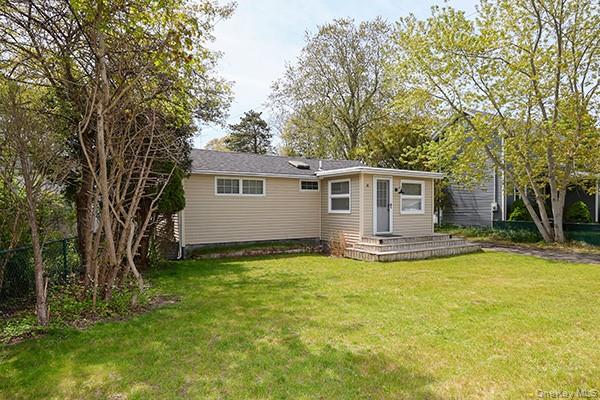 14 Lincoln Road Hampton Bays, NY 11946 - Photo 2 of 34 a view of a house with a yard and a large tree