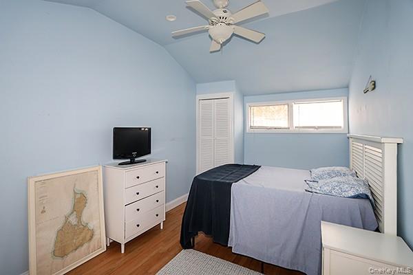 14 Lincoln Road Hampton Bays, NY 11946 - Photo 23 of 34 a bedroom with a bed and a television