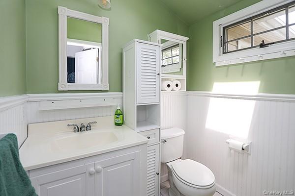 14 Lincoln Road Hampton Bays, NY 11946 - Photo 25 of 34 a bathroom with a sink a toilet and mirror