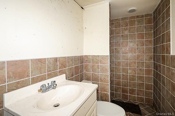 14 Lincoln Road Hampton Bays, NY 11946 - Photo 26 of 34 a bathroom with a sink toilet and a mirror