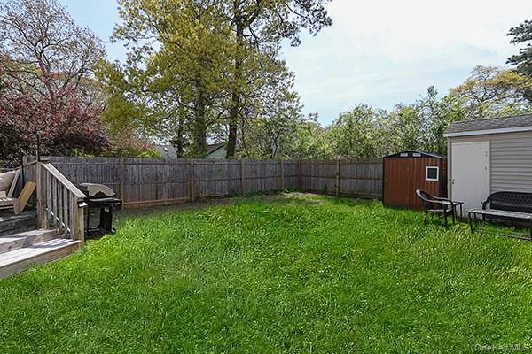 14 Lincoln Road Hampton Bays, NY 11946 - Photo 4 of 34 a view of a backyard with furniture