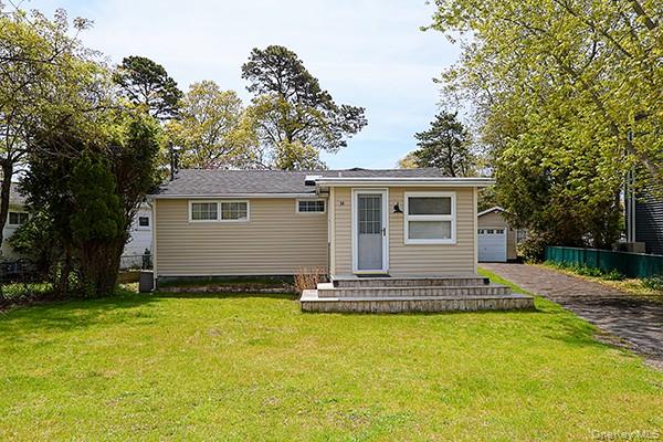 14 Lincoln Road Hampton Bays, NY 11946 - Photo 5 of 34 a front view of house with yard and trees in the background