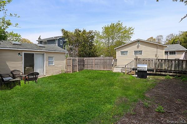 14 Lincoln Road Hampton Bays, NY 11946 - Photo 6 of 34 a view of backyard with barbeque grill and plants