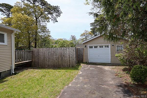 14 Lincoln Road Hampton Bays, NY 11946 - Photo 7 of 34 a view of barn with a small yard and large trees