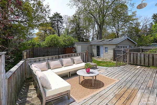 14 Lincoln Road Hampton Bays, NY 11946 - Photo 8 of 34 a view of a patio with couches chairs and a wooden floor
