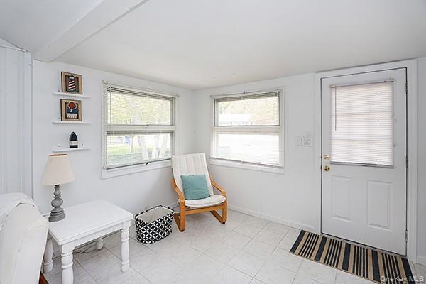 14 Lincoln Road Hampton Bays, NY 11946 - Photo 9 of 34 a living room with furniture and windows