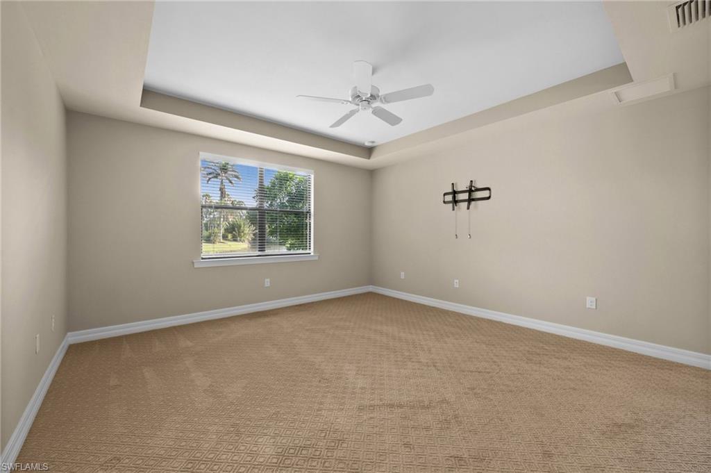14650 Laguna Drive Fort Myers, FL 33908 - Photo 28 of 50 an empty room with windows and ceiling fan