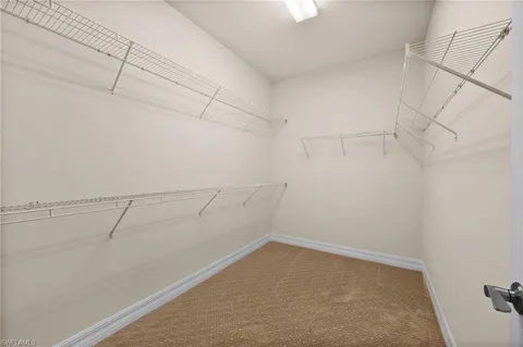 a spacious bathroom with a double vanity sink a large mirror and a shower