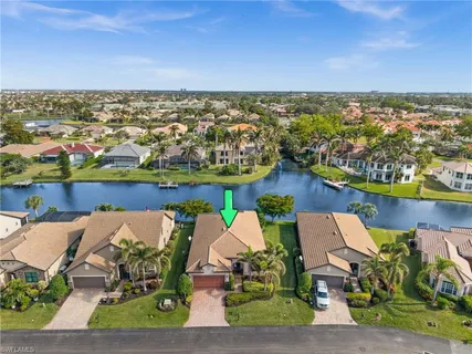 a view of a ocean with boats and palm trees