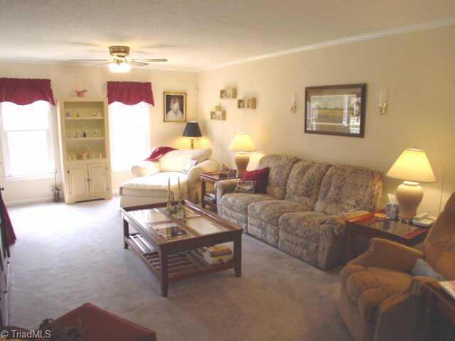 5509 Stonebridge Road Pleasant Garden, NC 27313 - Photo 2 of 9 Other. Large living room with double ceiling fans and gas log fireplace.