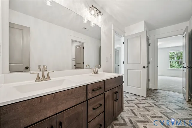 a bathroom with a sink double vanity granite tub shower and a mirror