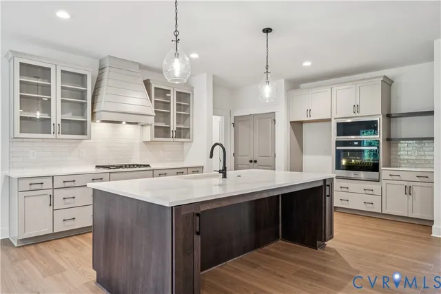 a kitchen with a sink stove and cabinets