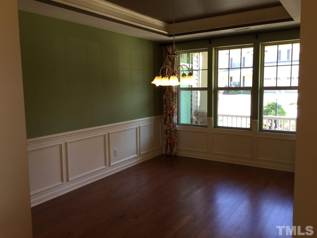 1314 Ranchester Road Knightdale, NC 27545 - Photo 11 of 25 a view of an empty room with wooden floor and a window