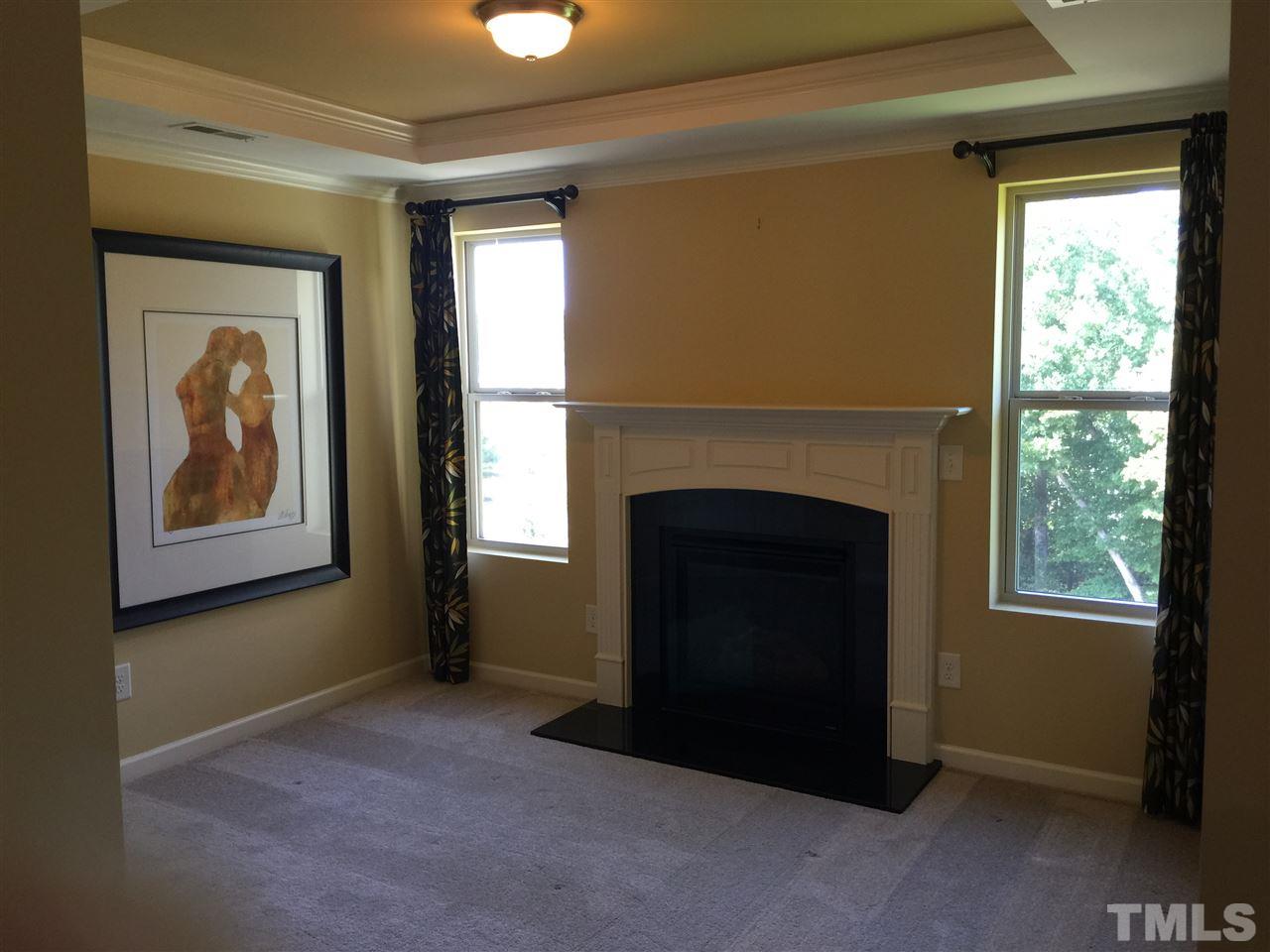 1314 Ranchester Road Knightdale, NC 27545 - Photo 16 of 25 a living room with a fireplace and a window