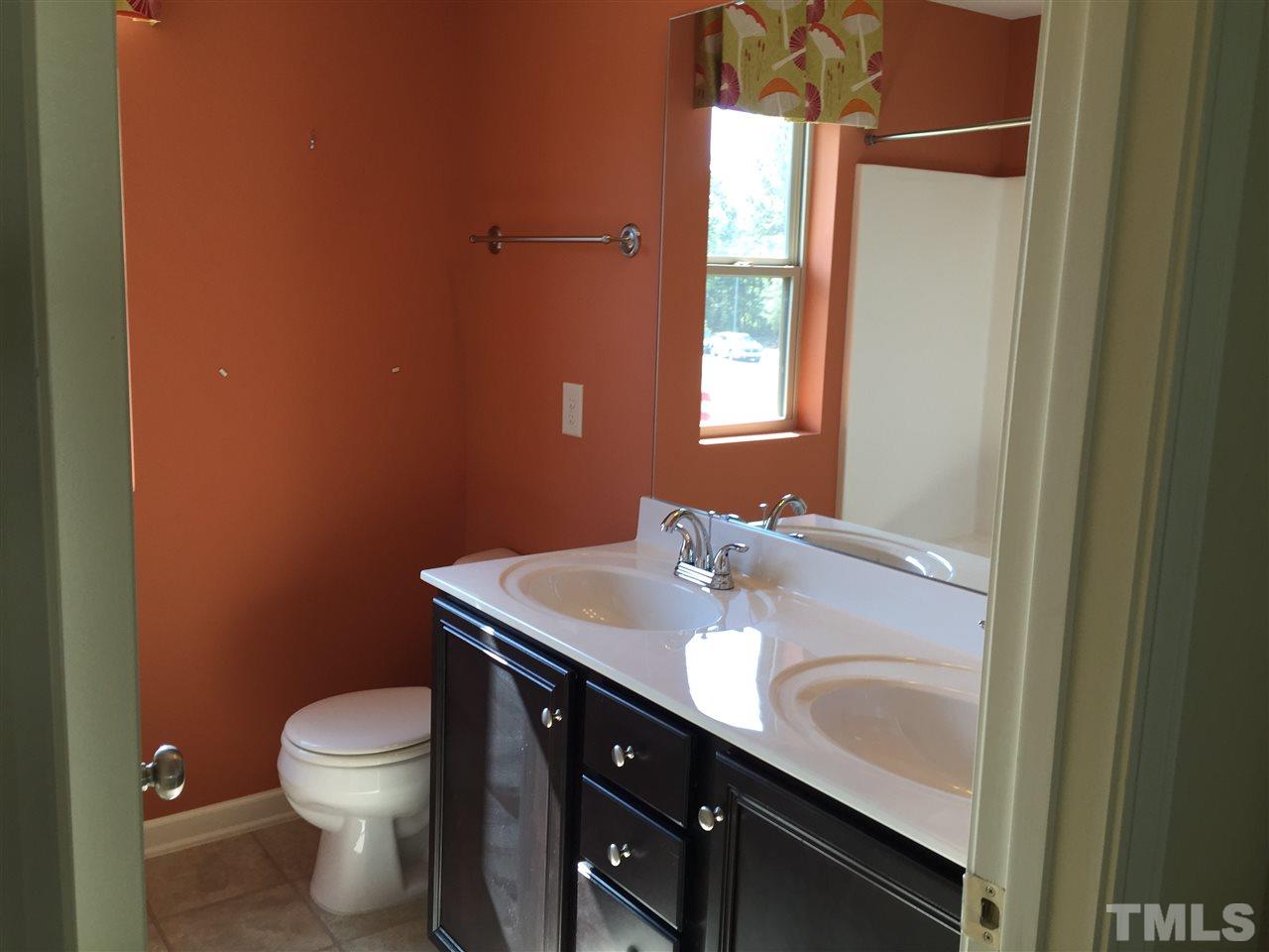 1314 Ranchester Road Knightdale, NC 27545 - Photo 22 of 25 a bathroom with a granite countertop sink toilet and a mirror