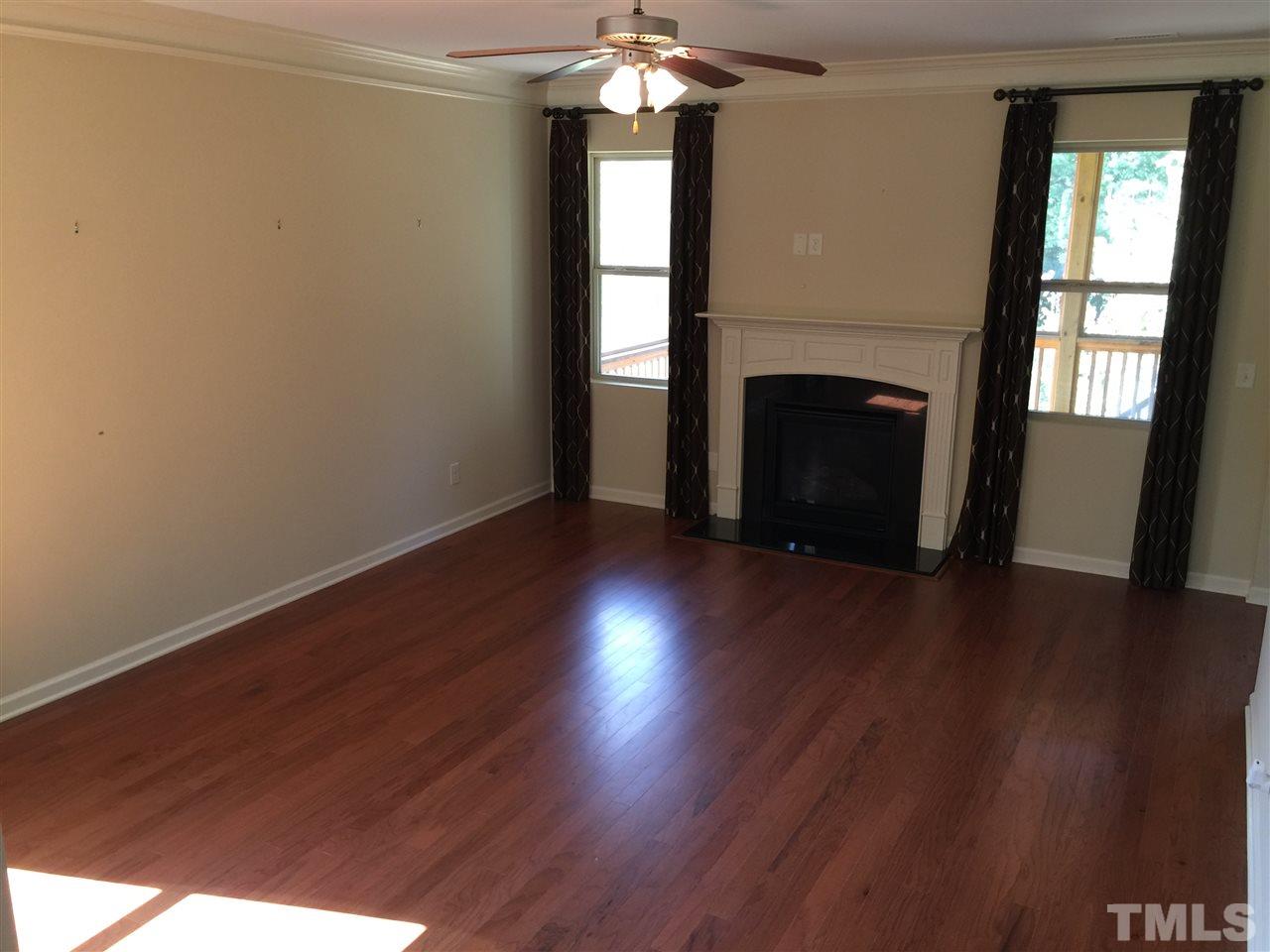 1314 Ranchester Road Knightdale, NC 27545 - Photo 25 of 25 a view of an empty room with wooden floor and a window
