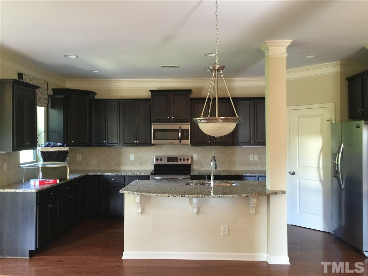 1314 Ranchester Road Knightdale, NC 27545 - Photo 8 of 25 a kitchen with stainless steel appliances granite countertop a sink a stove a refrigerator and a cabinets