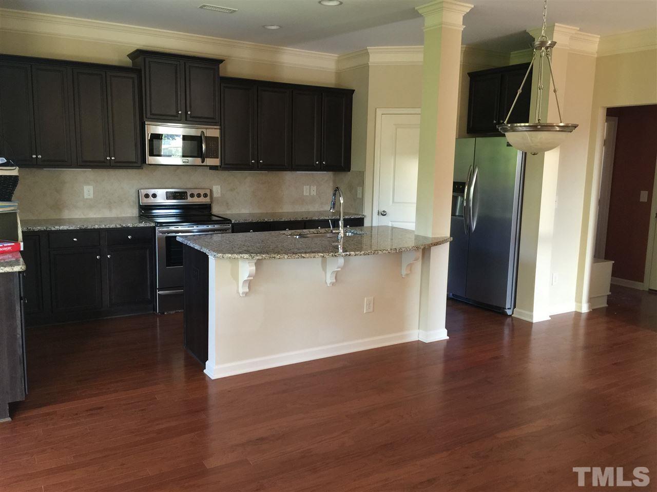 1314 Ranchester Road Knightdale, NC 27545 - Photo 9 of 25 a kitchen with stainless steel appliances granite countertop a refrigerator stove top oven and sink