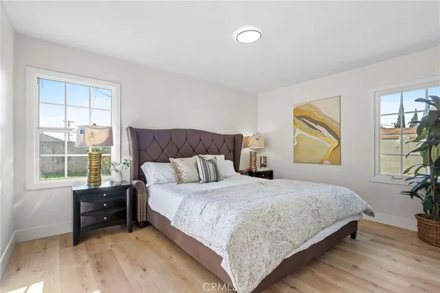 a bedroom with a bed and wooden floor