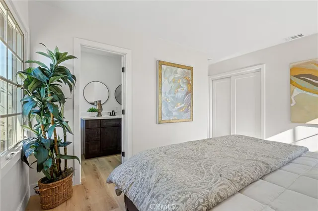 a bedroom with furniture and a potted plant