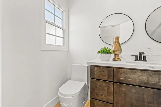 a bathroom with a sink mirror and toilet