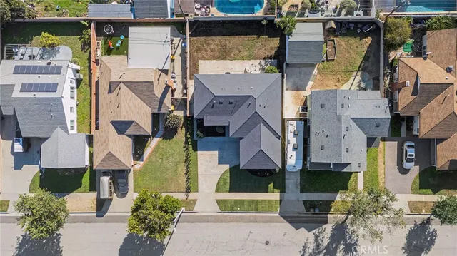 an aerial view of residential houses with outdoor space