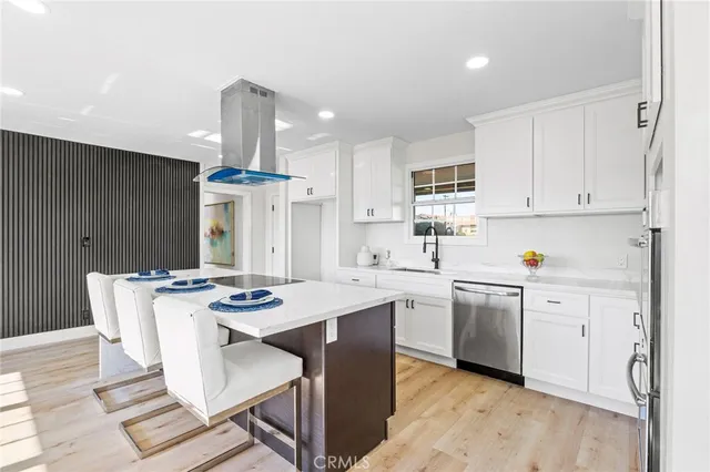 a kitchen with stainless steel appliances kitchen island granite countertop a dining table and chairs