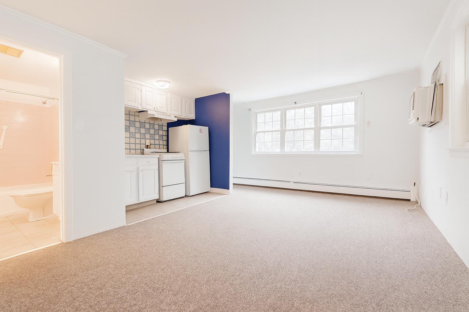3040 Falmouth Road, Unit F3 Osterville, MA 02655 - Photo 8 of 14 an empty room with windows and cabinet