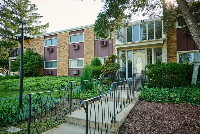 front view of a brick house with a yard