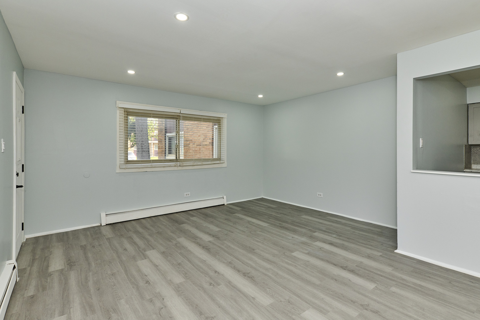 1320 Lore Lane, Unit 101A Lombard, IL 60148 - Photo 11 of 65 an empty room with wooden floor and windows