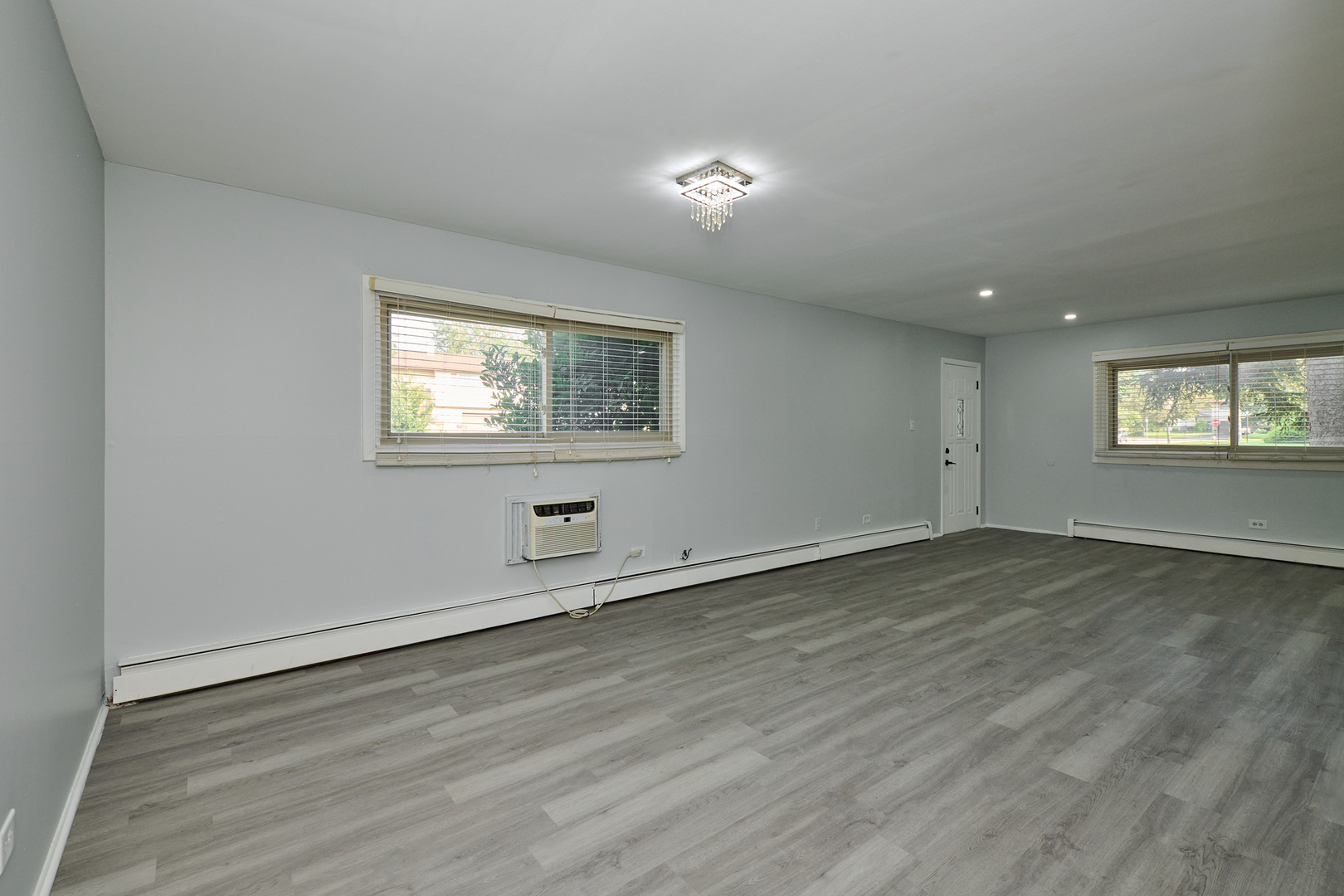 1320 Lore Lane, Unit 101A Lombard, IL 60148 - Photo 12 of 65 an empty room with wooden floor and windows