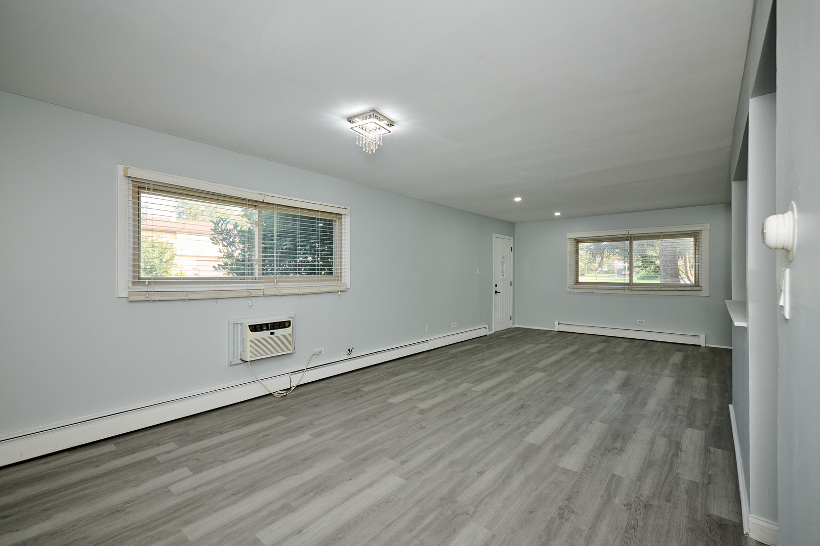 1320 Lore Lane, Unit 101A Lombard, IL 60148 - Photo 13 of 65 a view of an empty room with wooden floor and a window