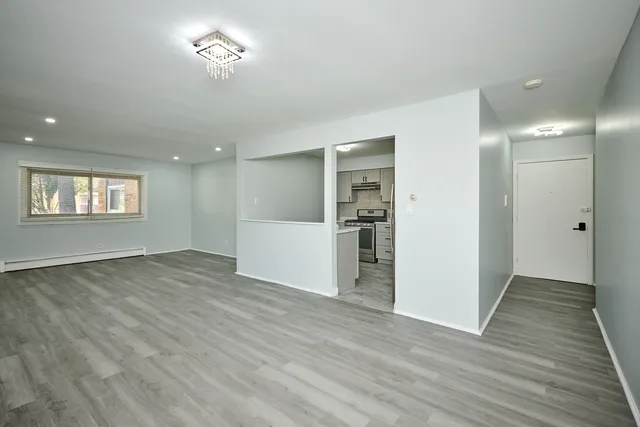 a kitchen with granite countertop white cabinets and stainless steel appliances