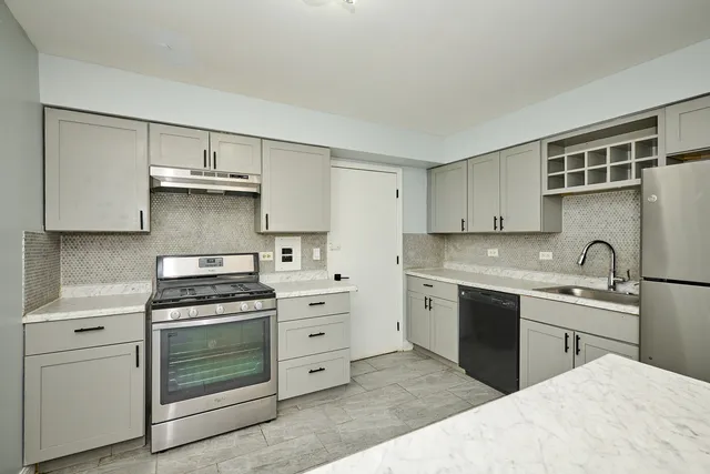 a view of a kitchen with a sink and a refrigerator