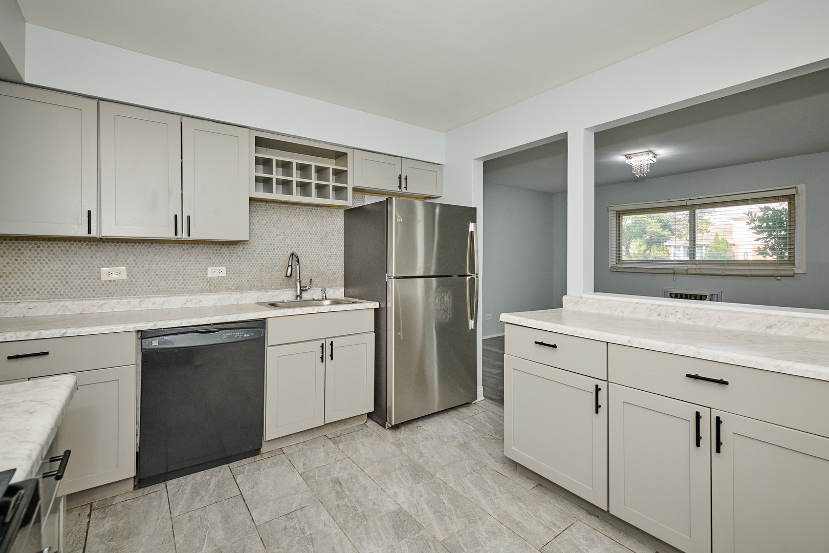 1320 Lore Lane, Unit 101A Lombard, IL 60148 - Photo 24 of 65 a kitchen with a sink cabinets and appliances