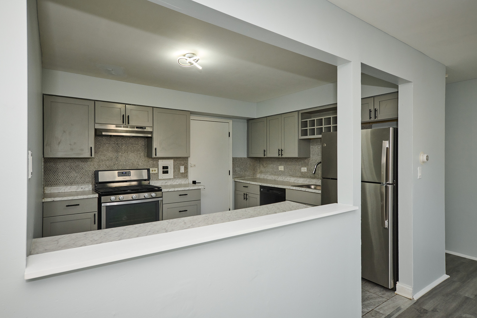 1320 Lore Lane, Unit 101A Lombard, IL 60148 - Photo 26 of 65 a kitchen with stainless steel appliances granite countertop a refrigerator and a stove